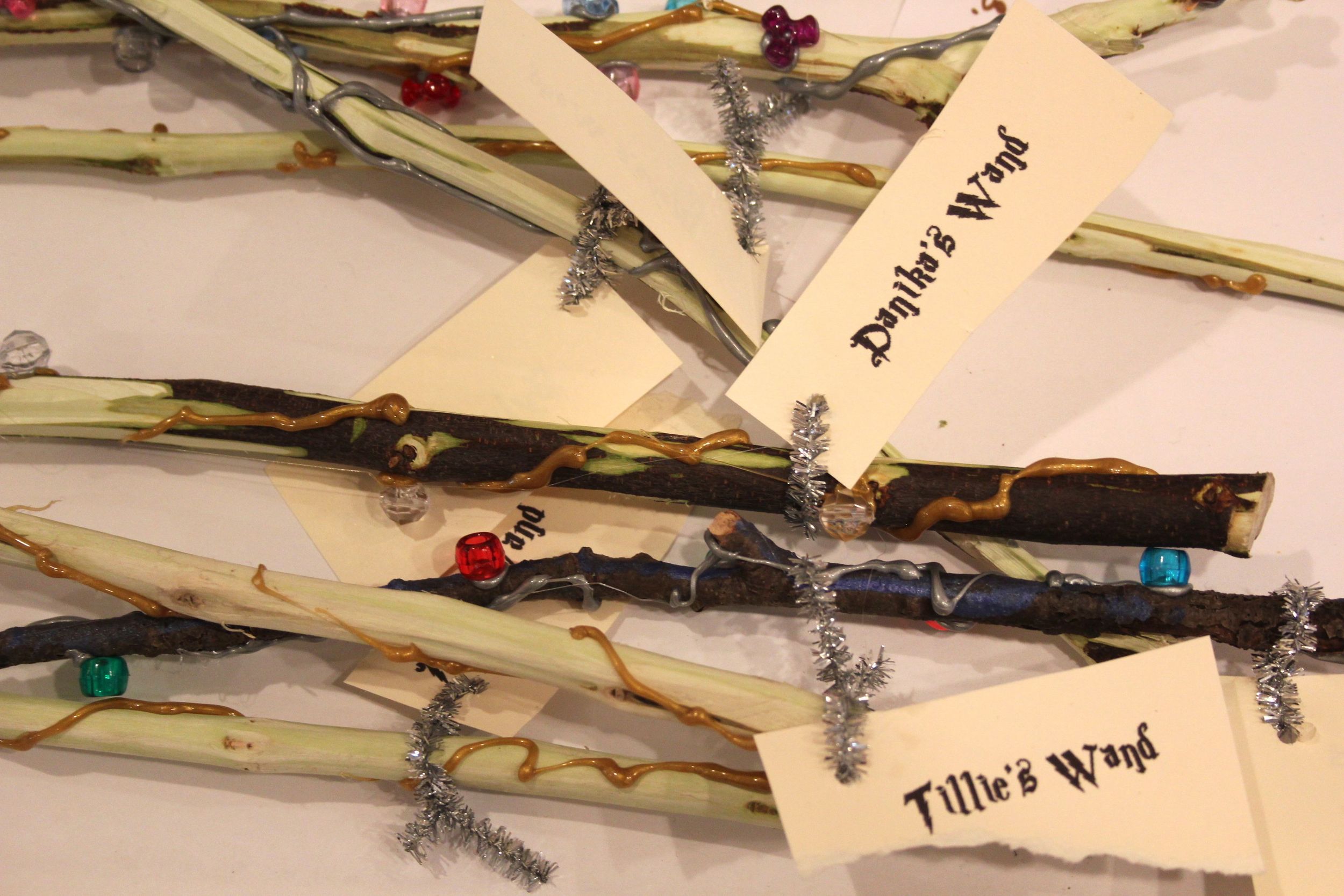  Wands (twigs) decorated with beads and sliver/gold hot glue.