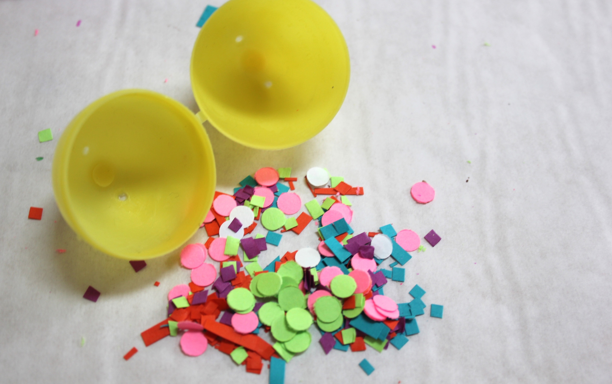 Fill leftover eggs with confetti made with a hole punch and scissors (those fringe scissors can make tiny square confetti too). Put the confetti in the egg and tape it closed.
