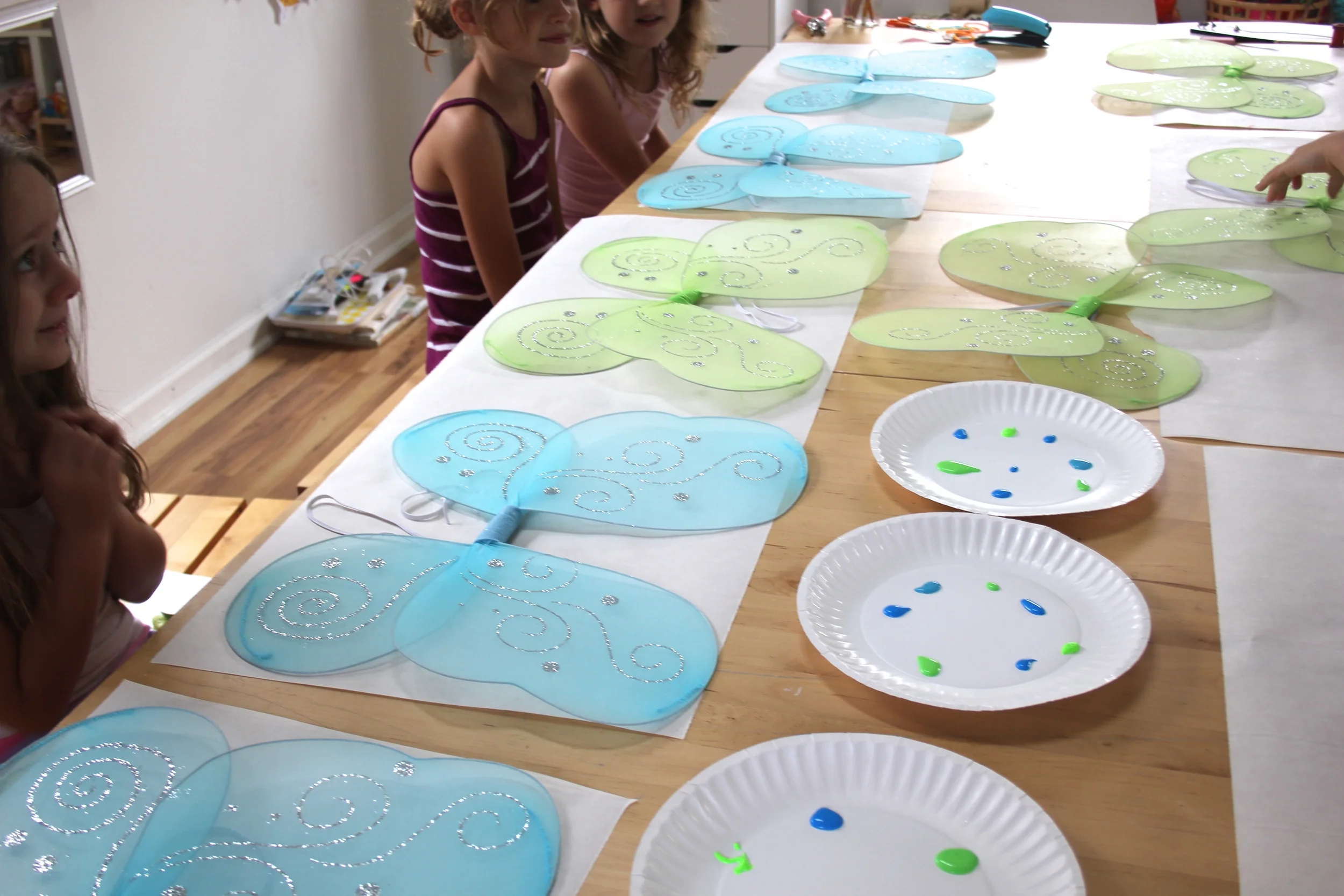 A table of fairy wings ready to be painted and clothesline dried.
