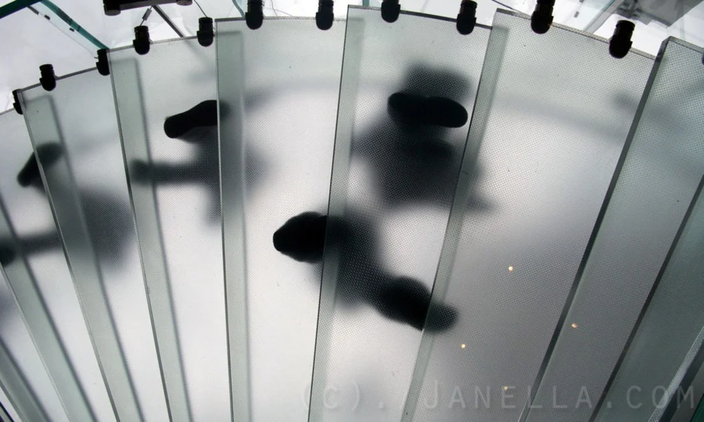 Walking down the spiral staircase at the Apple Store.