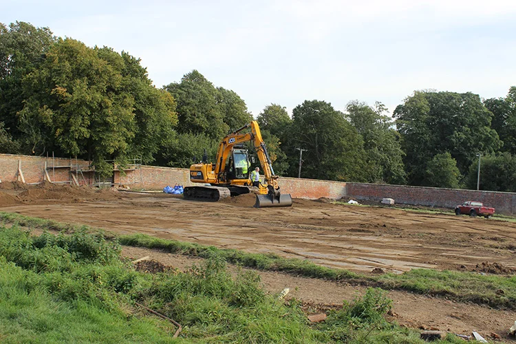 Landscape works underway within the walled garden .