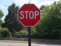 Stop signs are my single largest annoyance about cycling and driving in the States. Every other country in the world seems to get by just fine with give ways, which allow the driver/cyclist the opportunity to roll straight into the junction if it is clear obviating the need to waste energy in stopping and starting. Replacing most stop signs with give ways would have a positive impact on fuel economy, the constants top start regime is a total waste of energy. As a cyclist 99% of all stop signs are completely irrelevant, you can safely merge with traffic without the need for coming to a complete halt. However in this fair country they employ highly paid police officers to sit around on street corners fining cyclists and drivers that don't come to a complete stop at this unnecessary red signs. I was very fortunate on my first ride to work that they were too busy fining other cyclists to stop me. This was on a very lightly trafficked industrial estate, where stopping at the signs for safety reasons is a completely redundant argument. There were three motorcycle police at three different junctions within 200m of each other. The whole thing kills the flow of riding.
Please America lets have some more give ways and roundabouts and drop the idiocy that is the stop sign.