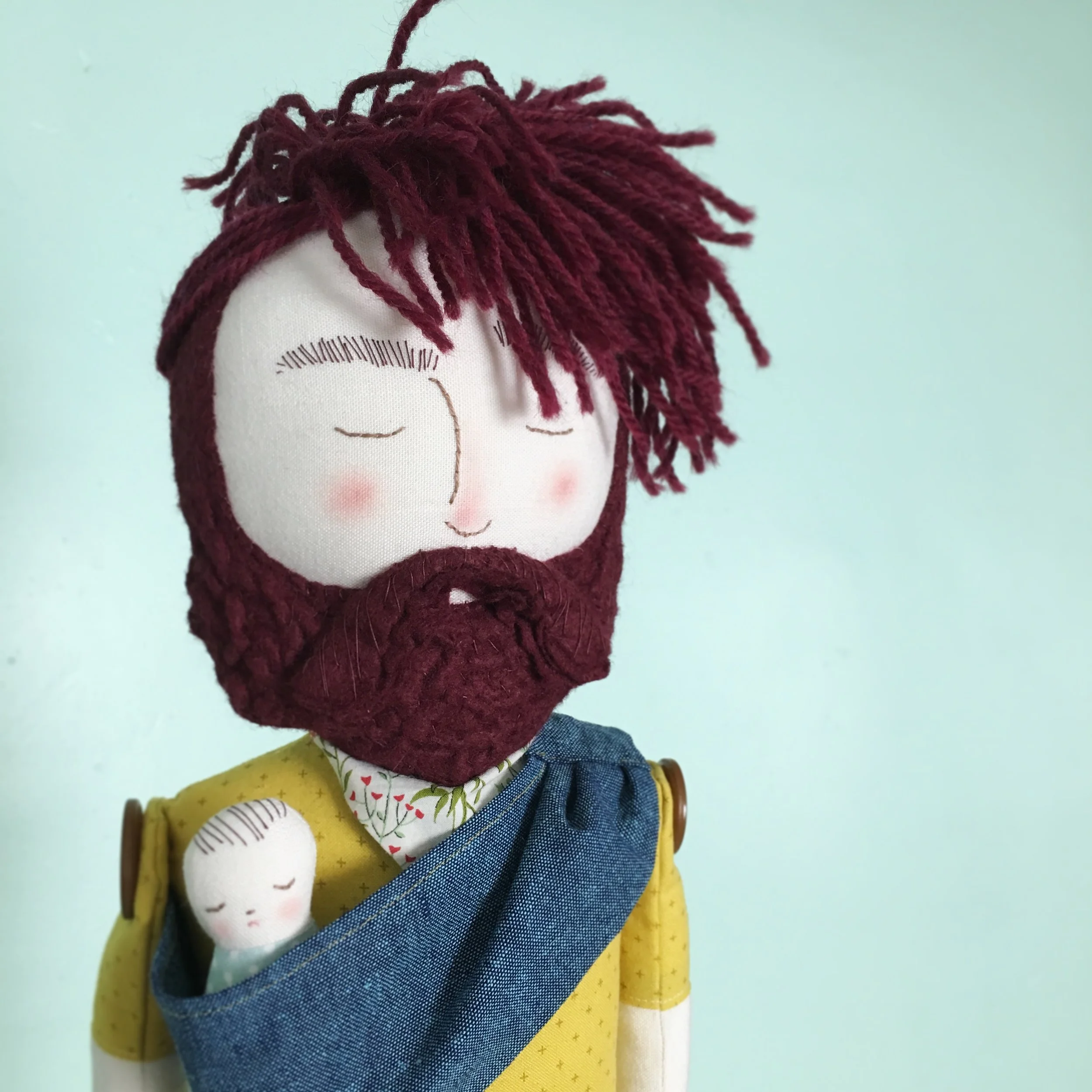 hipster dad doll wearing a baby