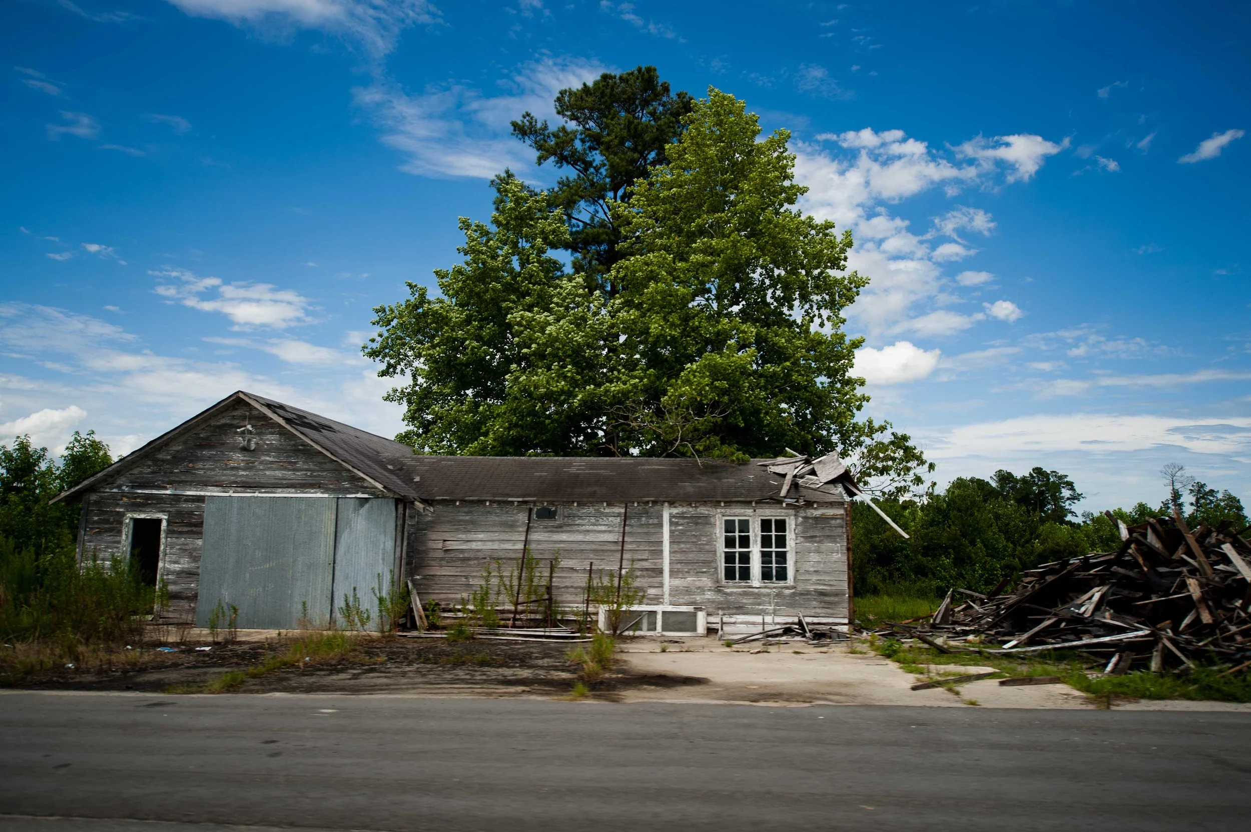 Bet this old farmhouse was nicer before a highway was run through the front yard.
