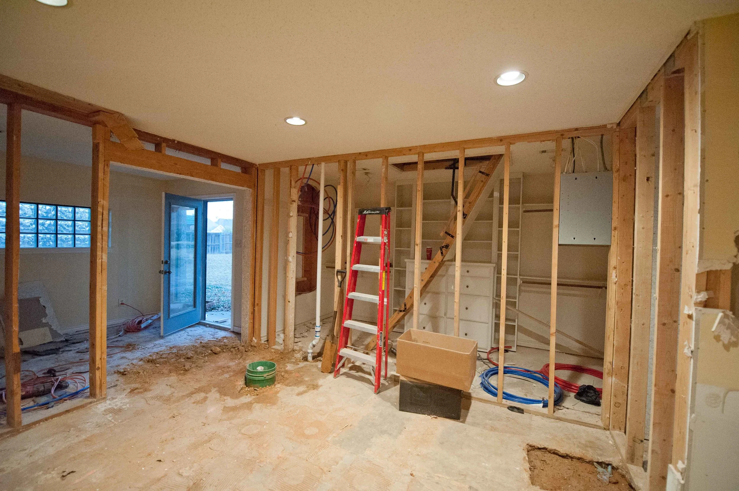 The expanded master closet is straight ahead. Where the ladder stands is about at the right edge of the new shower, and in the room to the left (which will officially cease to be a separate room when the rest of the wall comes down) will be our double vanity being lovingly built by Rocket. Bigger windows will be on that wall as well, bringing in some more light to the whole space. 