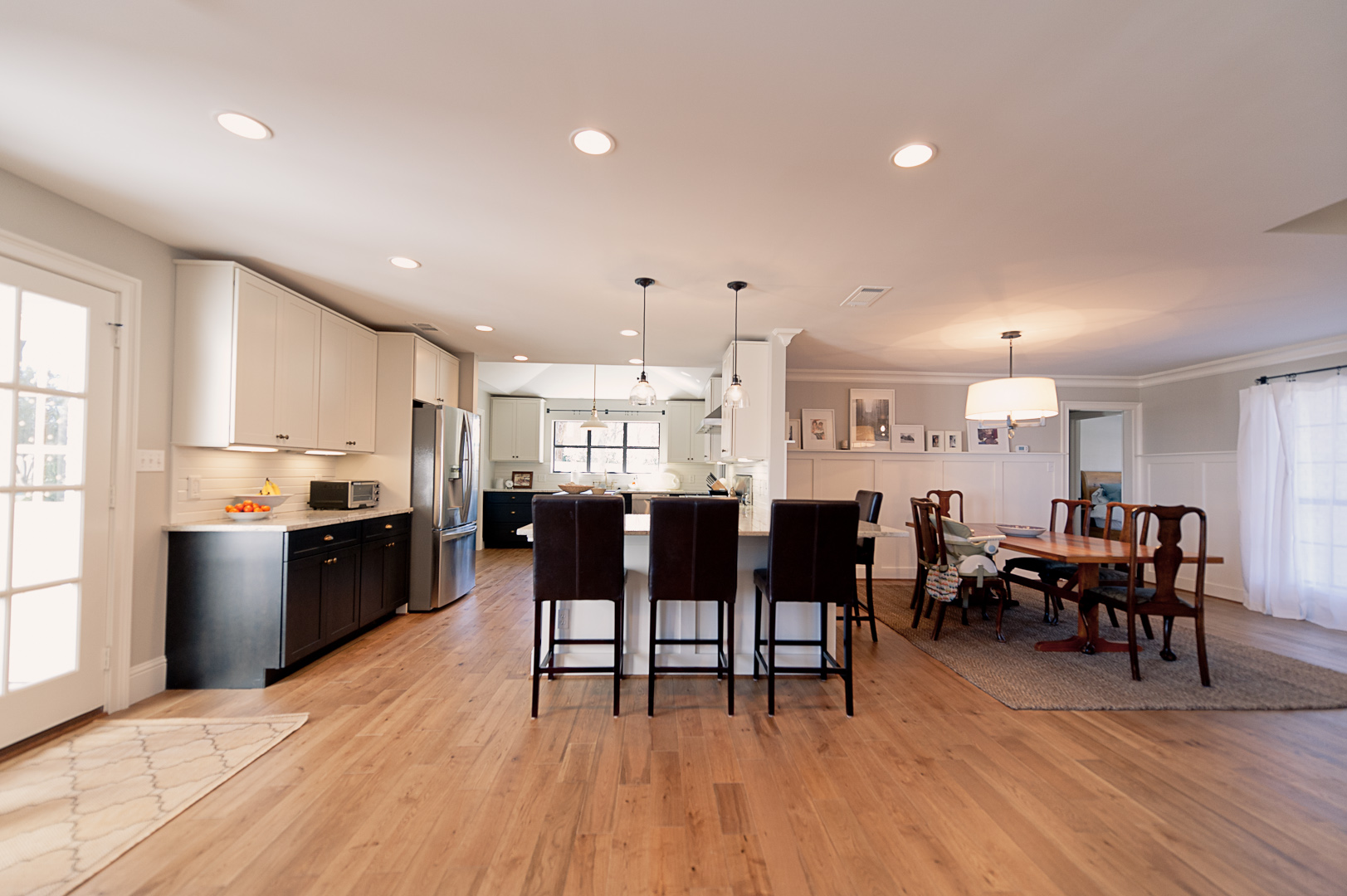 After: This isn't the same vantage point, but you see the same space.&nbsp; Where there was a small window over the kitchen sink, there is now a set of French doors.&nbsp; And the wall with the stove top and microwave is completely gone.&nbsp; We do…