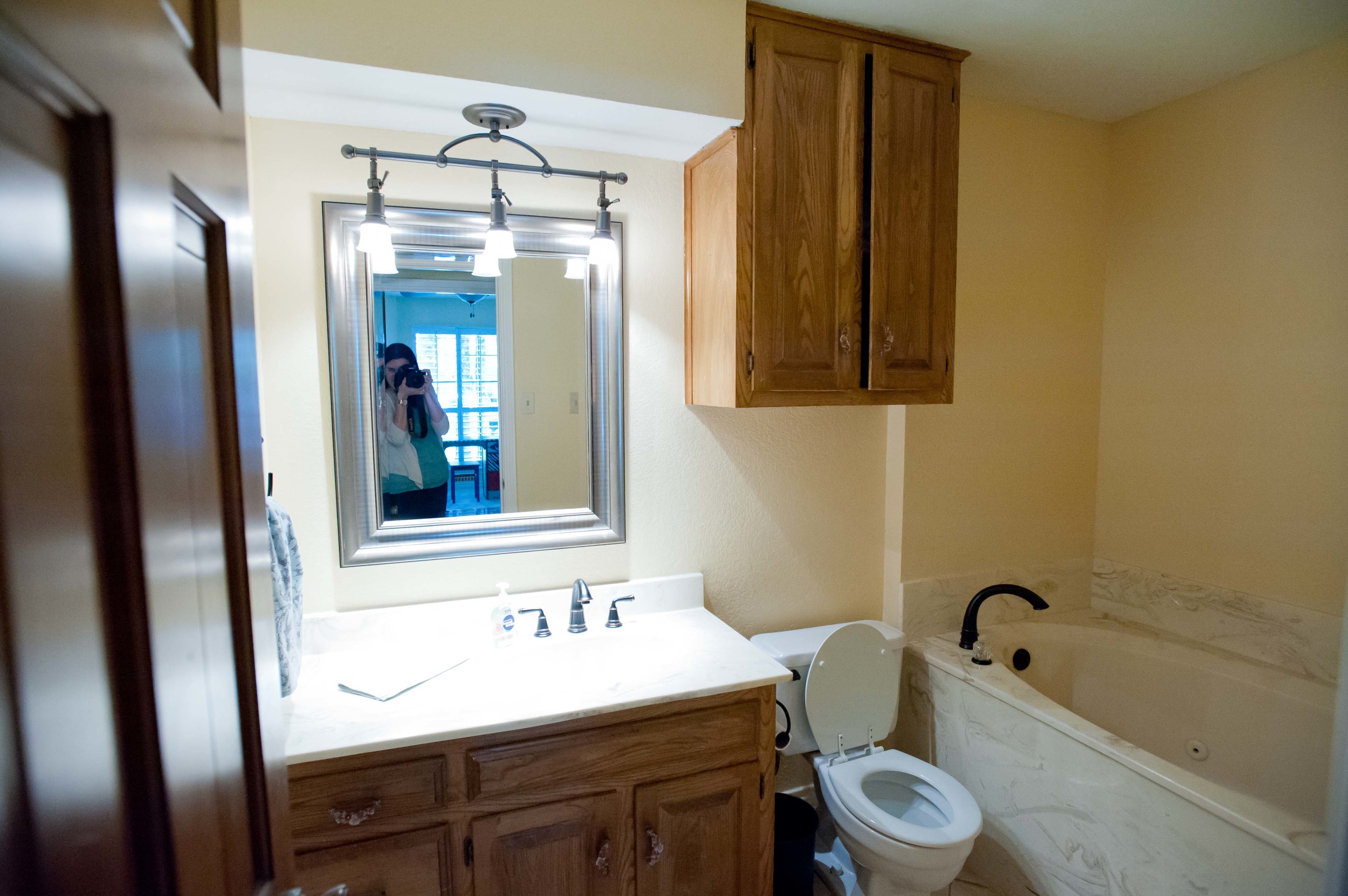 Before: Unnecessary bulk head, a tub with no shower that was very difficult to get in and out of, and an upper cabinet that we removed.​