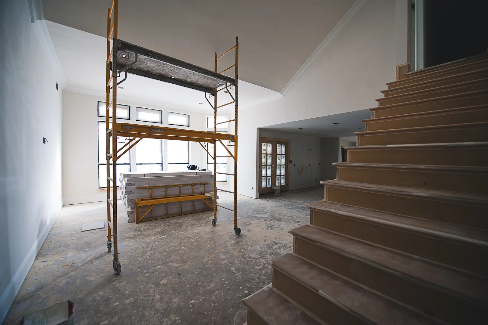 ​During: A large built-in along the wall opposite the kitchen was removed and the stairs got a facelift.&nbsp; We also removed the exterior door in the family room and replaced it with a set of windows to match the trio already there.&nbsp; Not havi…