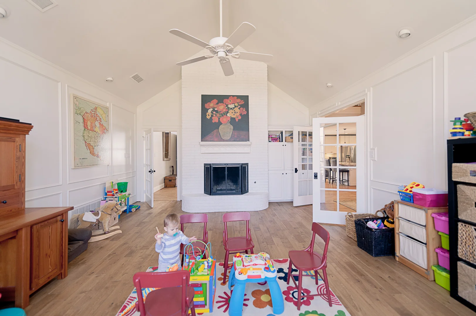 Aside from (lots of) paint and new floors, we opened up the height of the cased opening into the dining room to let more light through, and we added French doors in that opening as well as framing in a place for a door between the playroom and famil…