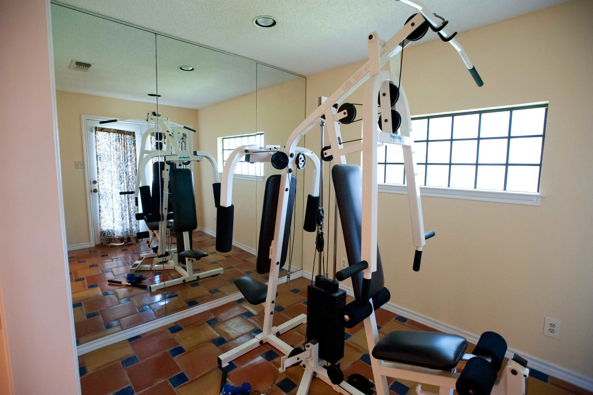 Adjacent to the bathroom was a mirrored workout room, with doors (not seen here) opening up to the backyard.​