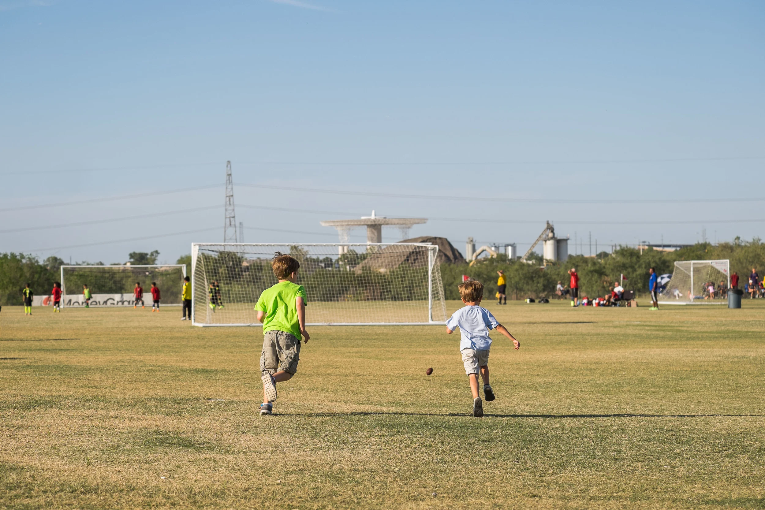 Later that afternoon...back in Dallas for another one of Ella's games. The boys had fun chasing around a mini-football Michael got at a friend's birthday party. 