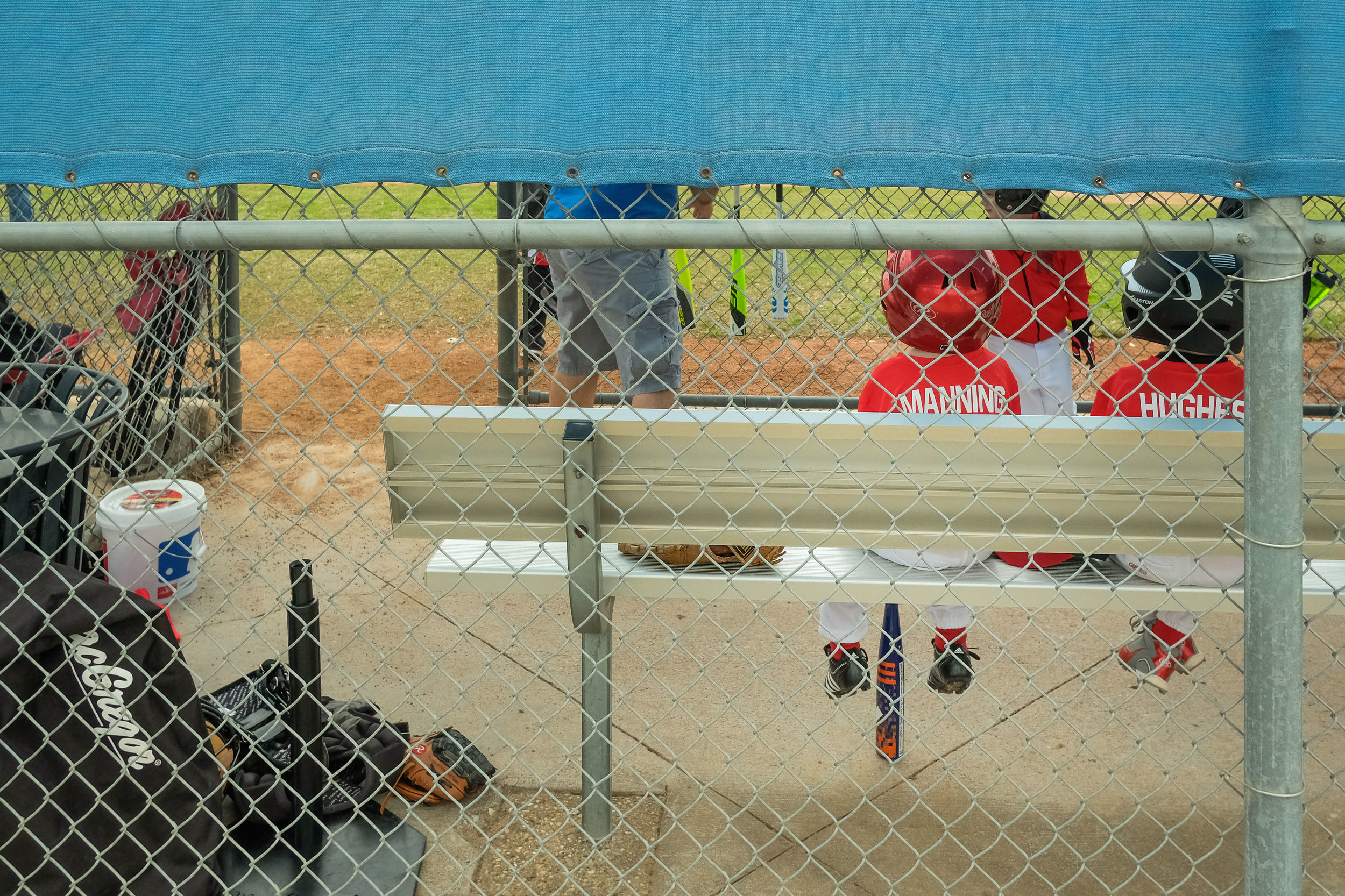 Watching the boys climb onto the dugout bench is really funny. 