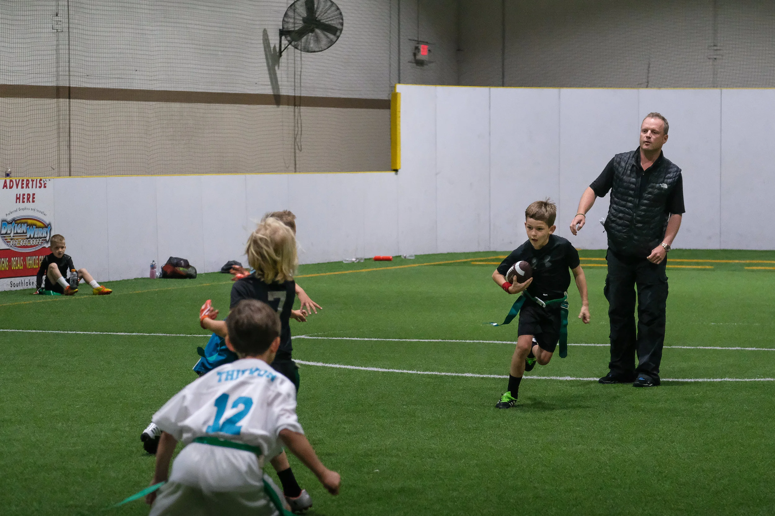We followed up T-ball with a (freezing) soccer game, sorry no photos...my fingers wouldn't bend...then on to Michael's flag football game. This is where I admit the embarrassing mom/photographer truth that my camera was stuck in a manual focus mode for the whole weekend that Poppa and Gigi visited. Any photos that are in focus were purely lucky ones. :( Good thing the season isn't over and we get to hang with the Mannings again in June!