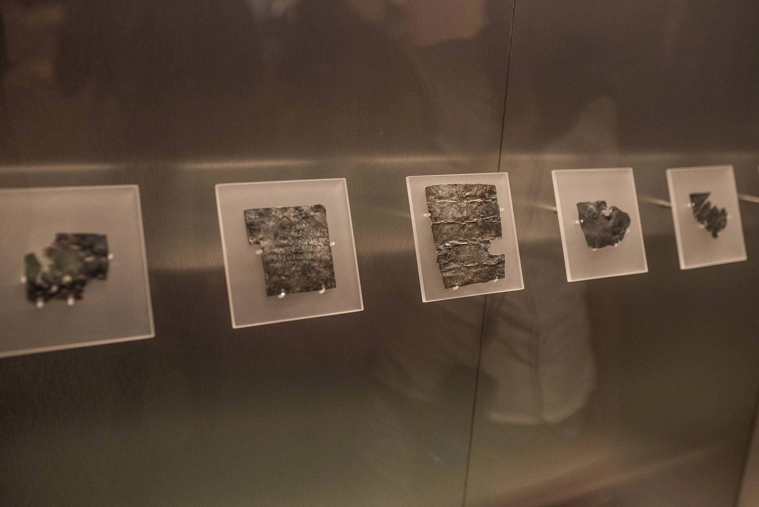 These small, metal tablets represent a sort of ancient Roman justice system. If someone was wronged by another, they would pay money to a scribe, assuming they didn't have the necessary skills themselves, who would then produce one of these tablets. The lines would often include the names and deeds of the guilty parties and a requested punishment from the person who would toss it into the water. 