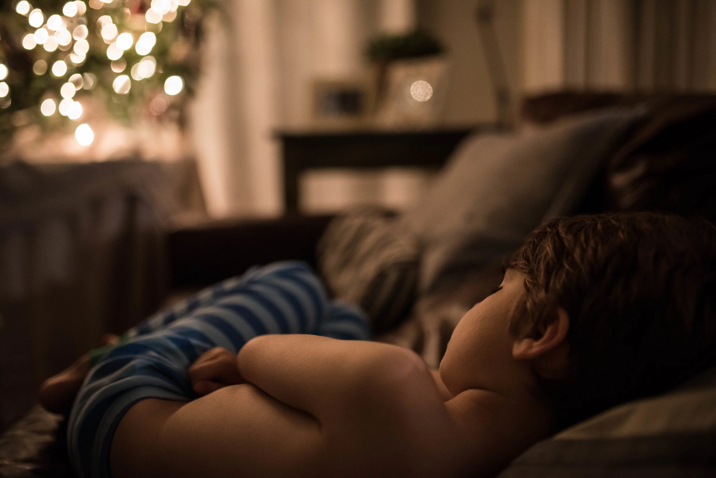 There's no more magical place to fall asleep than in front of the Christmas tree.
