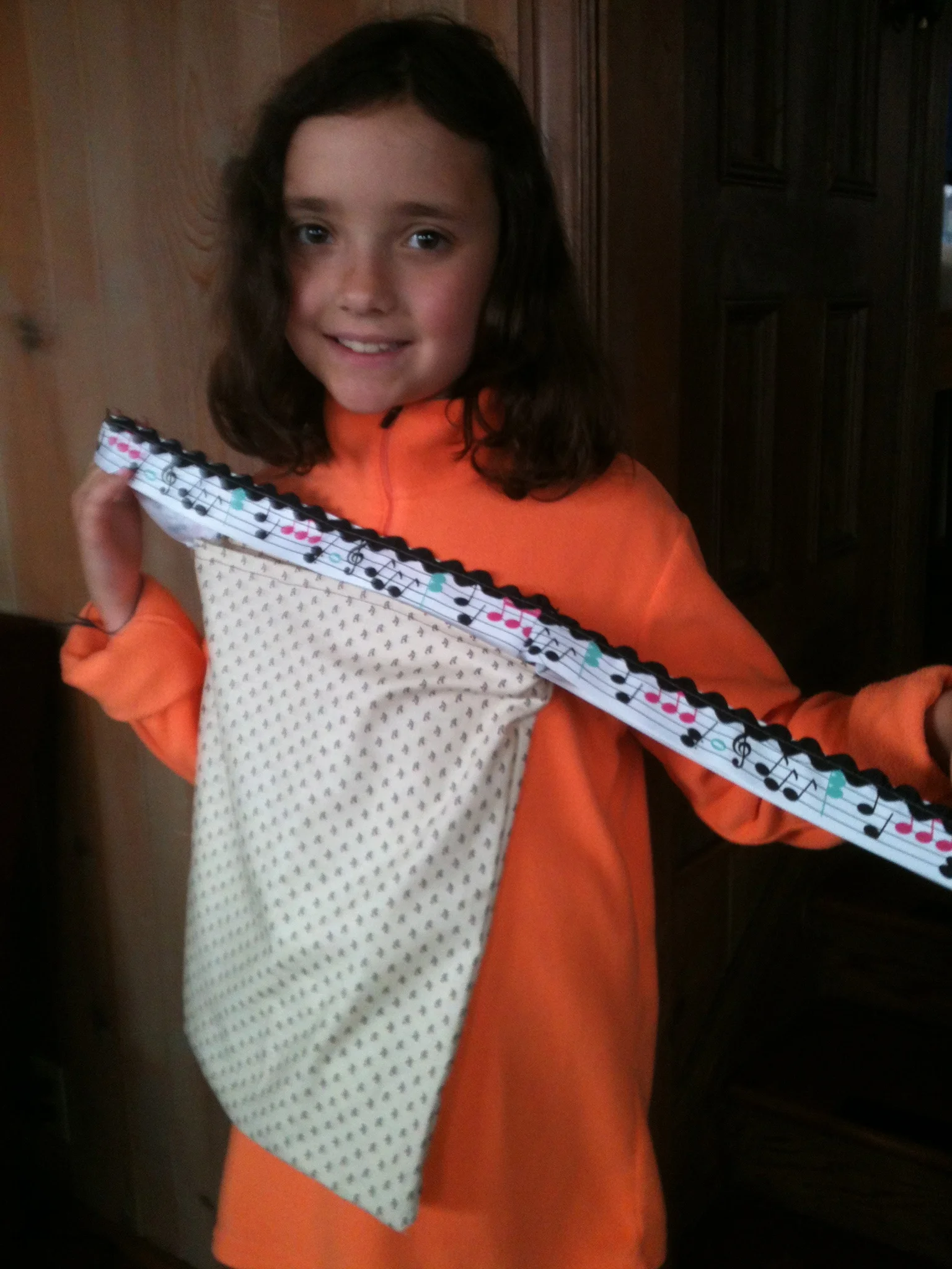 Maria shows off her new music bag. She made it herself. I love the ribbon she used to make the straps.
