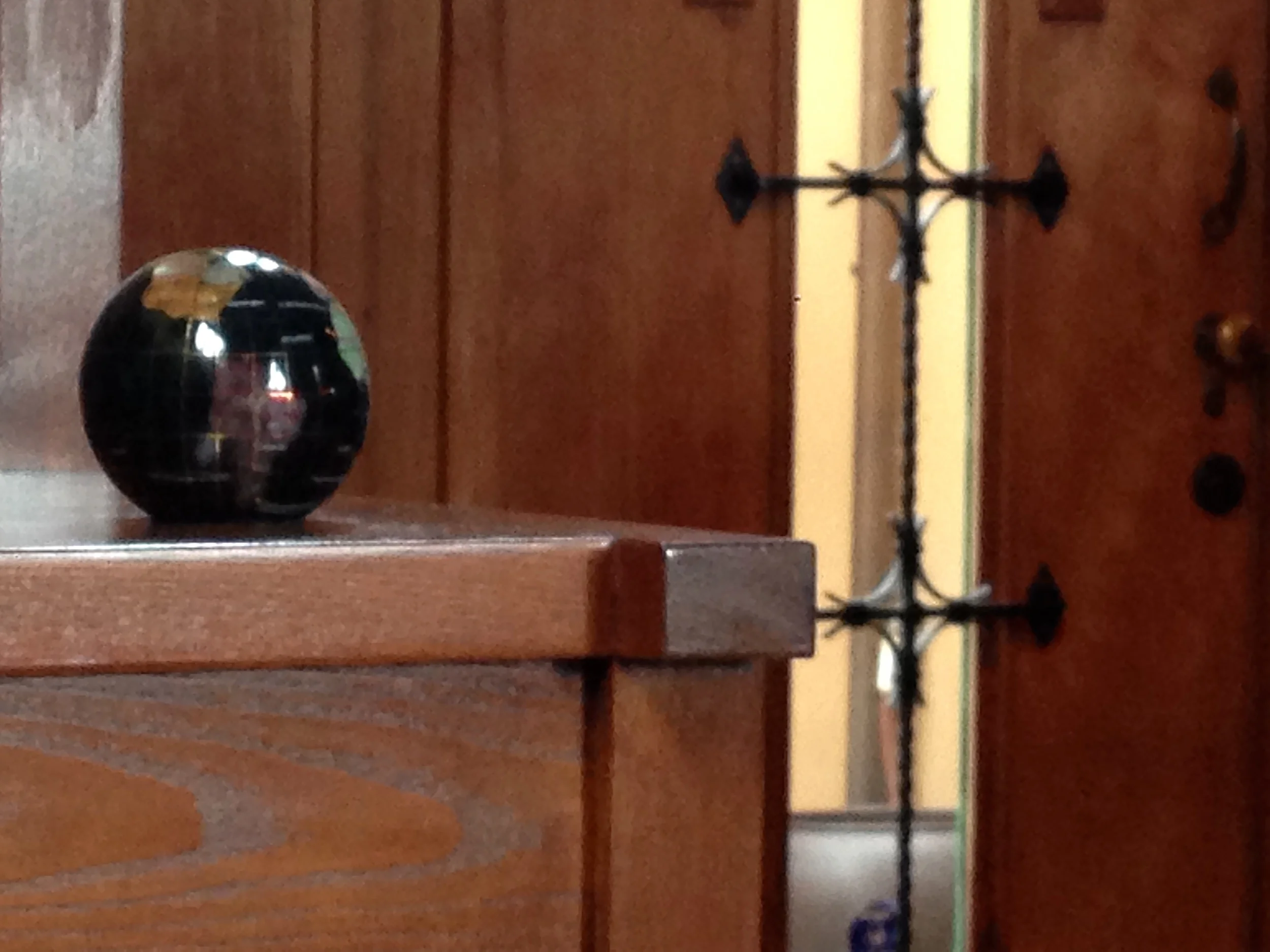 Globe on the stair step shelves.