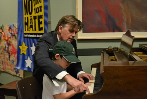 Stephen works with a young student at the Monarch School. 
