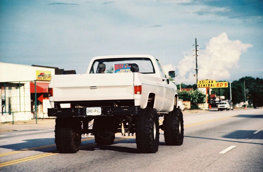 White Pick Up Truck With Mudders
