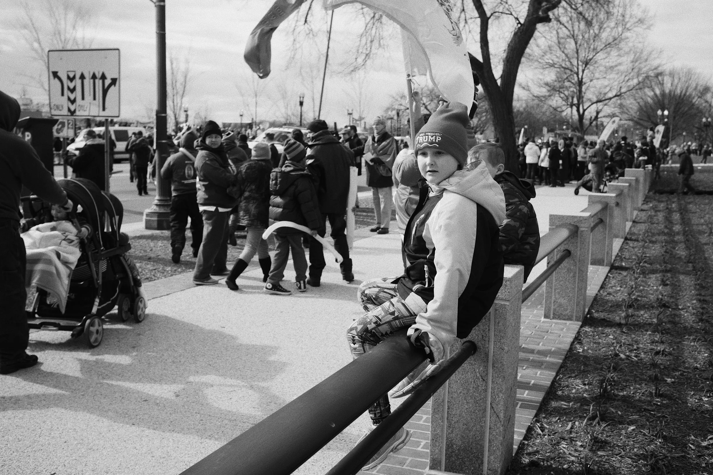 A young girl in a "Make America Great Again" hat.