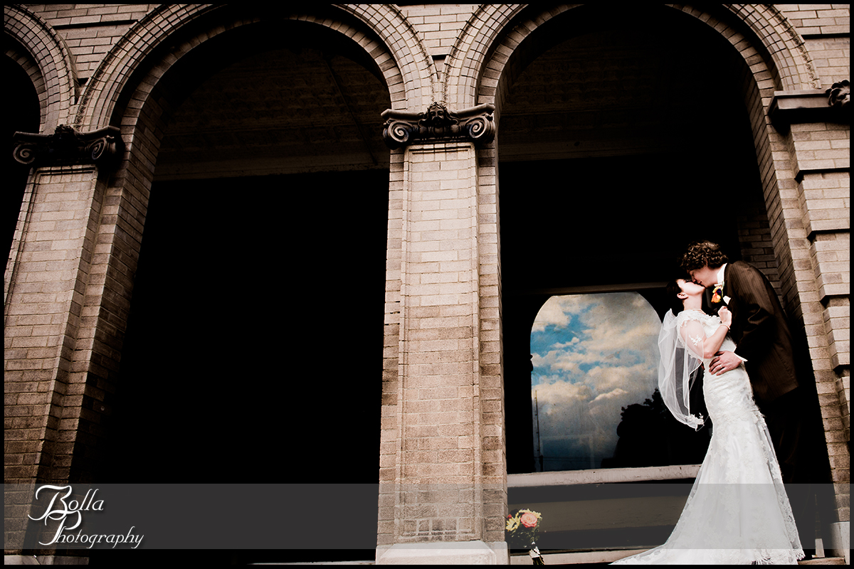 001_Bolla_Photography-wedding-fall-portraits-bride-groom-couple-kiss-Breese-Kuhl-arches-clouds.jpg