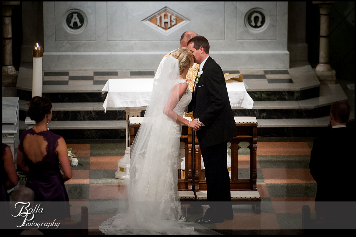 011-Bolla-Photography-wedding-Belleville-IL-ceremony-church-groom-bride-altar-first-kiss-Wilson.jpg