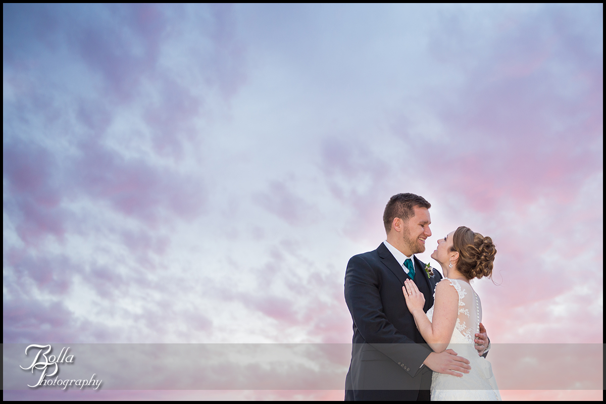 001-Bolla-Photography-Saint-Louis-wedding-photographer-McKendree-Bothwell-Chapel-Lebanon-IL-ceremony-Regency-OFallon-IL-reception-bride-groom-portraits-night-couple-sunset-clouds-kissing-McClain.jpg