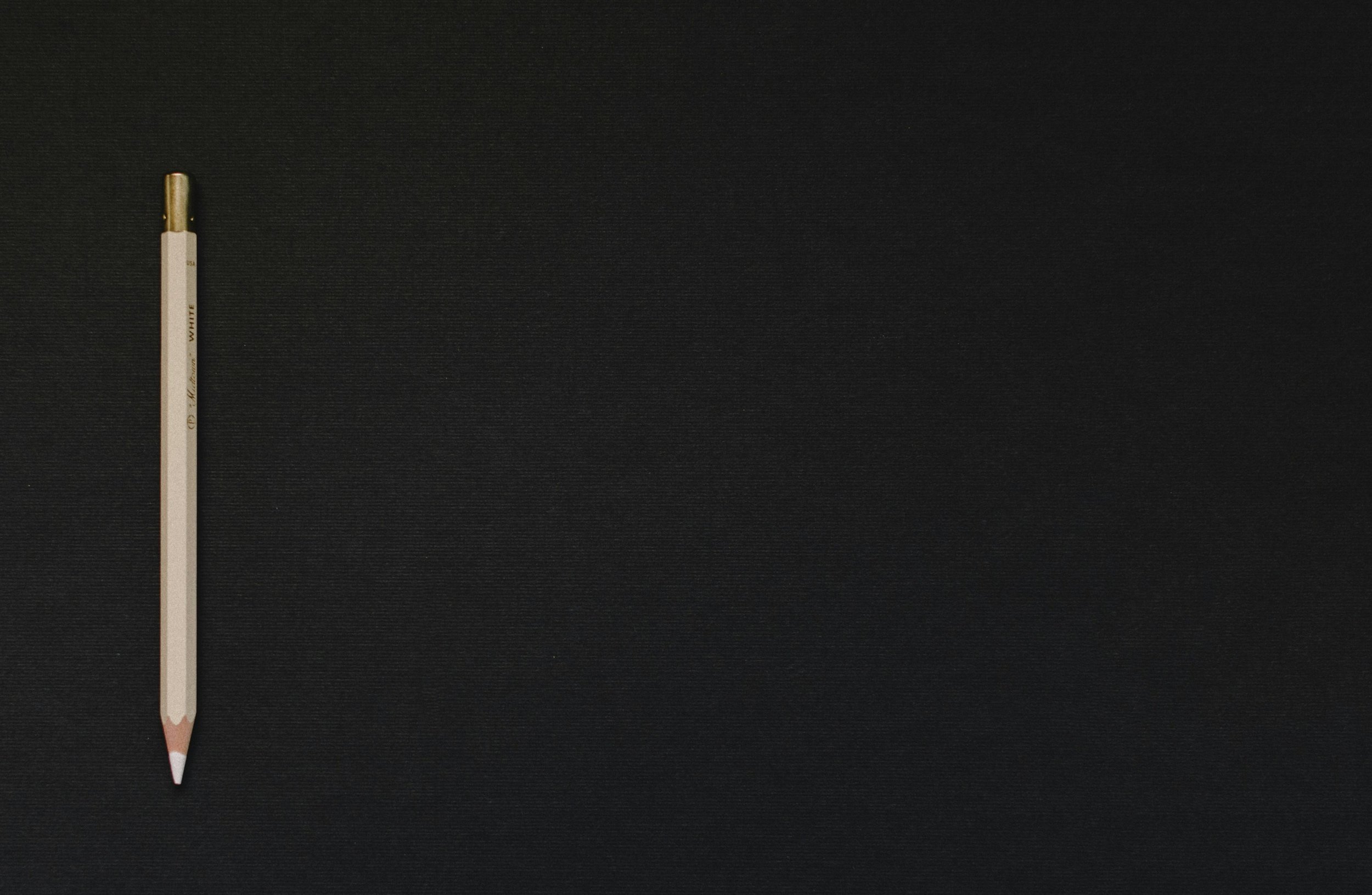 White pencil on black platform.jpg