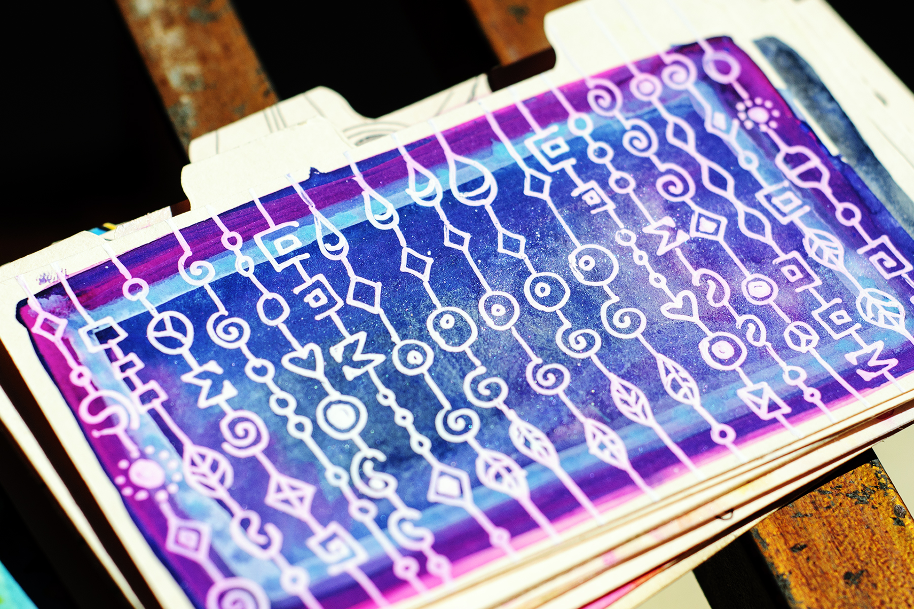 3x5" index card divider, white Uni-Ball Signo UM-153 on gouache background, artwork by Tammy Garcia.