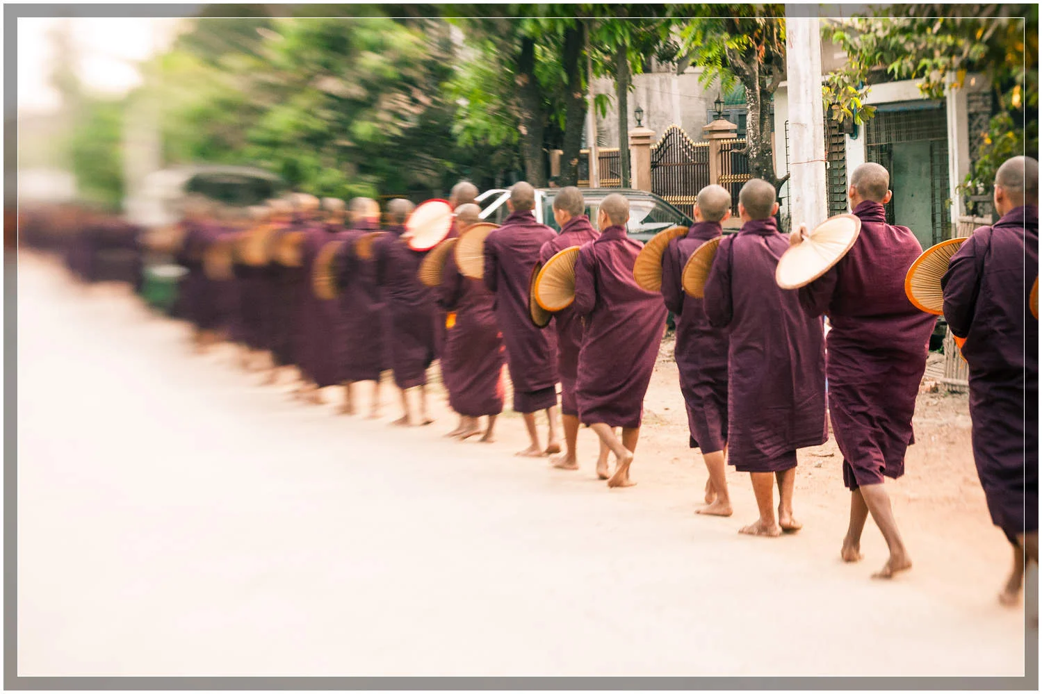 Monks form a line walking down the street in the town of Mawlamyine, a port city in south-eastern Myanmar (Burma) © Dustin Main 2013