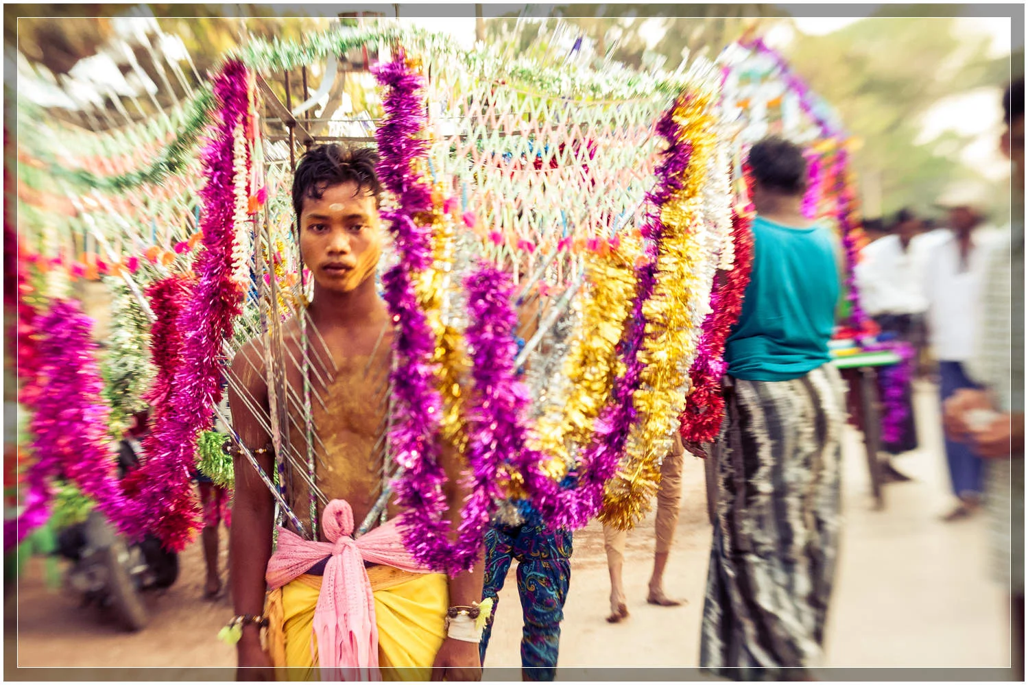 A Hindu devotee, decorated and pierced, makes the pilgrimage to the temple in the streets of Myanmar's third largest city, Mawlamyine. © Dustin Main 2013