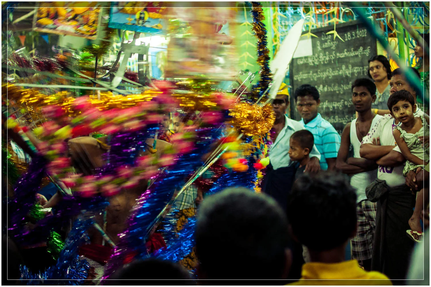 Onlookers watch as the devotees spin and dance to the undulating beat as they enter the temple and the ceremony comes to an end. © Dustin Main 2013