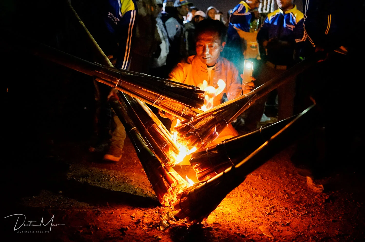 The fire that burns. Lighting the torches that will bring life to the fire balloons. © Dustin Main 2015