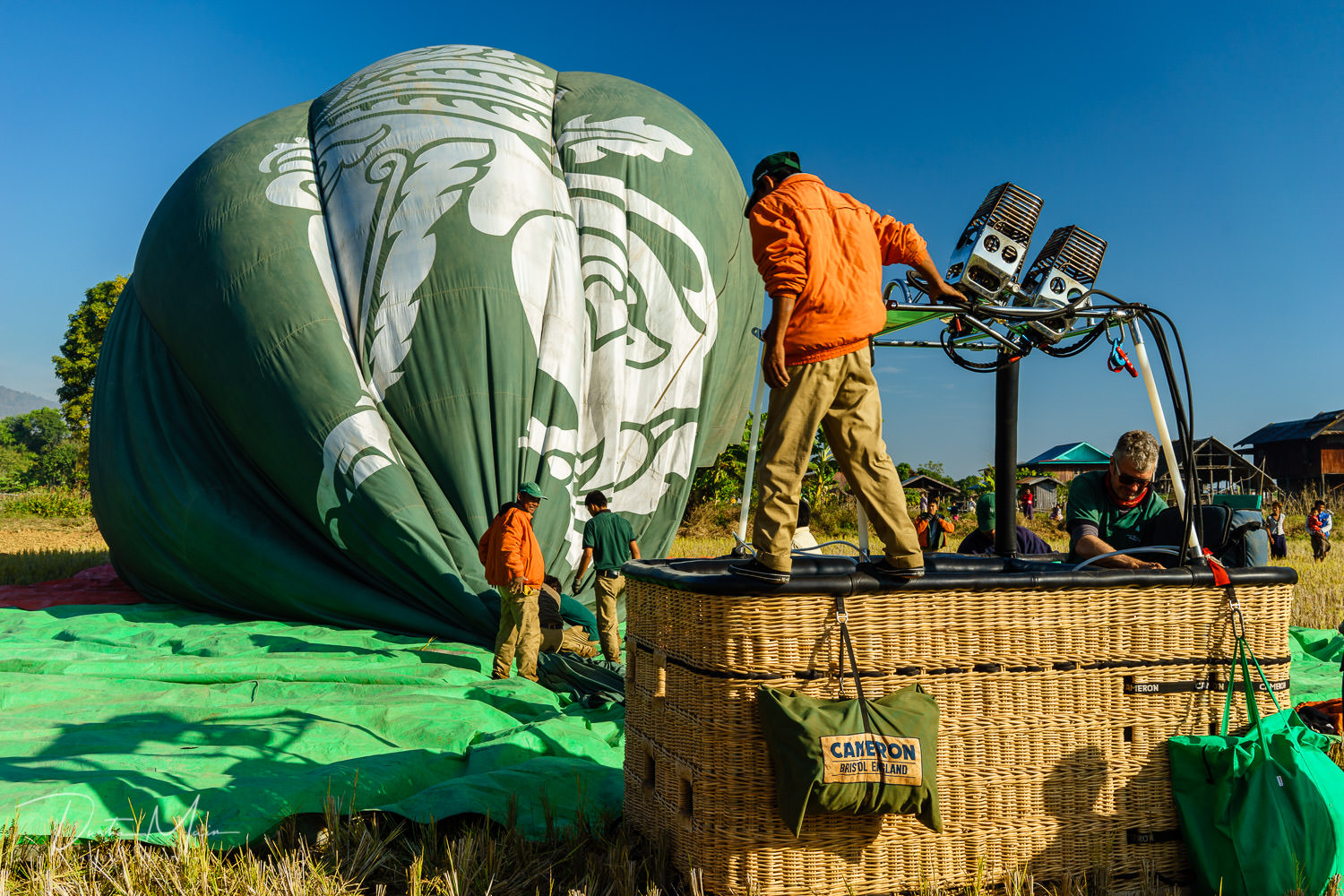  The ground crew begins the process of packing up the hot air balloon and basket before heading back to Nyaungshwe.  © Dustin Main 2017 