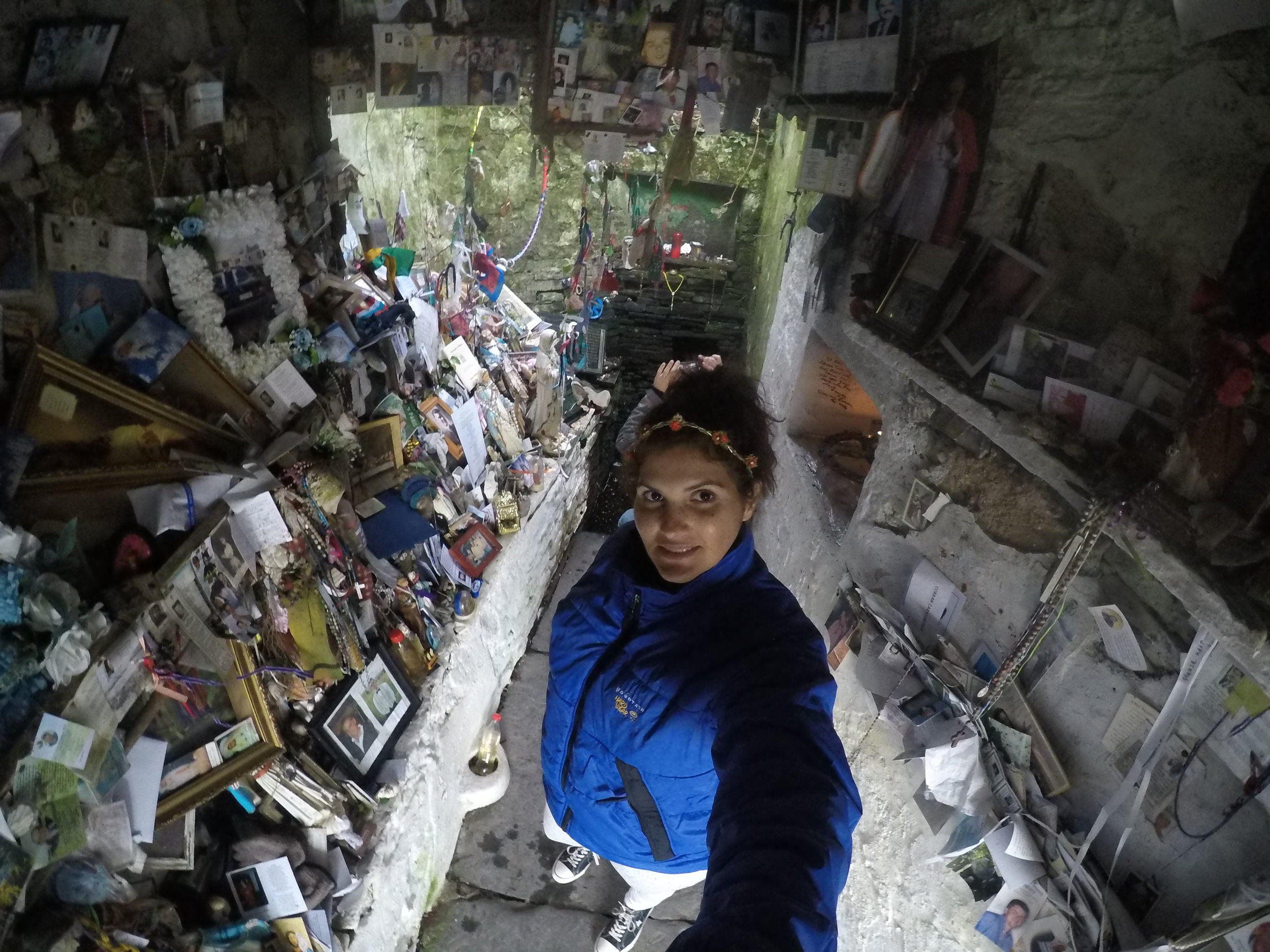 The well is located in a grotto, which has become filled with the offerings of many people over the years.