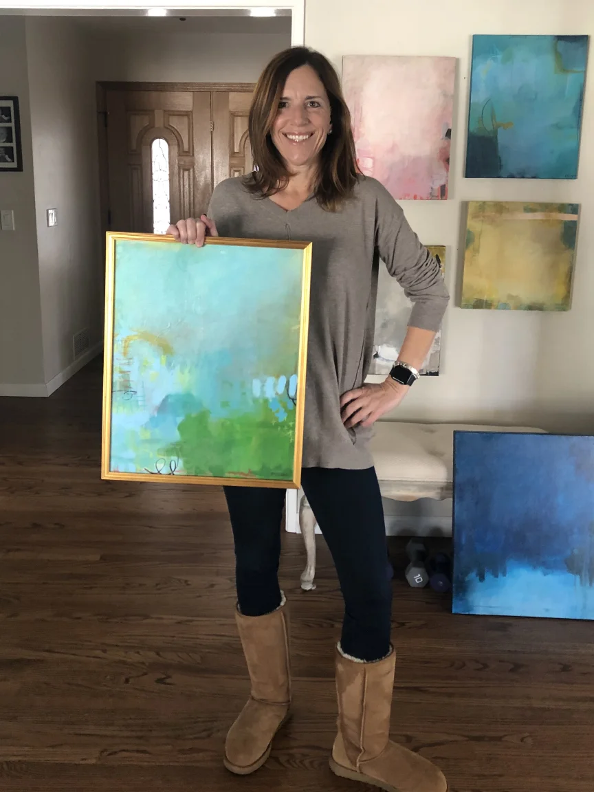 The artist standing with some available mixed media originals. Click here for cheap affordable great art.