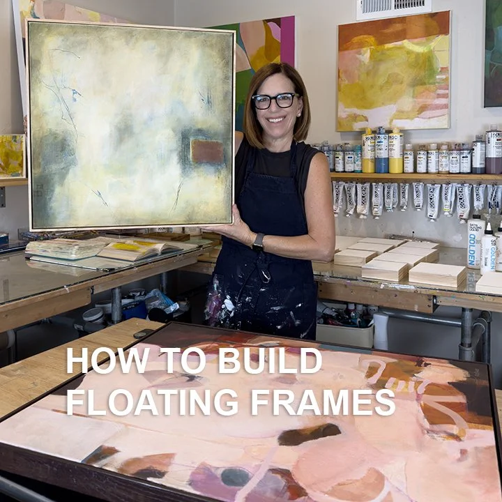 A woman in a black apron and glasses standing in an art studio, holding a large abstract painting. The studio has colorful abstract artworks on the walls and shelves filled with paint bottles. There are paintings on the table and the text 'HOW TO BUILD FLOATING FRAMES' at the bottom of the image.