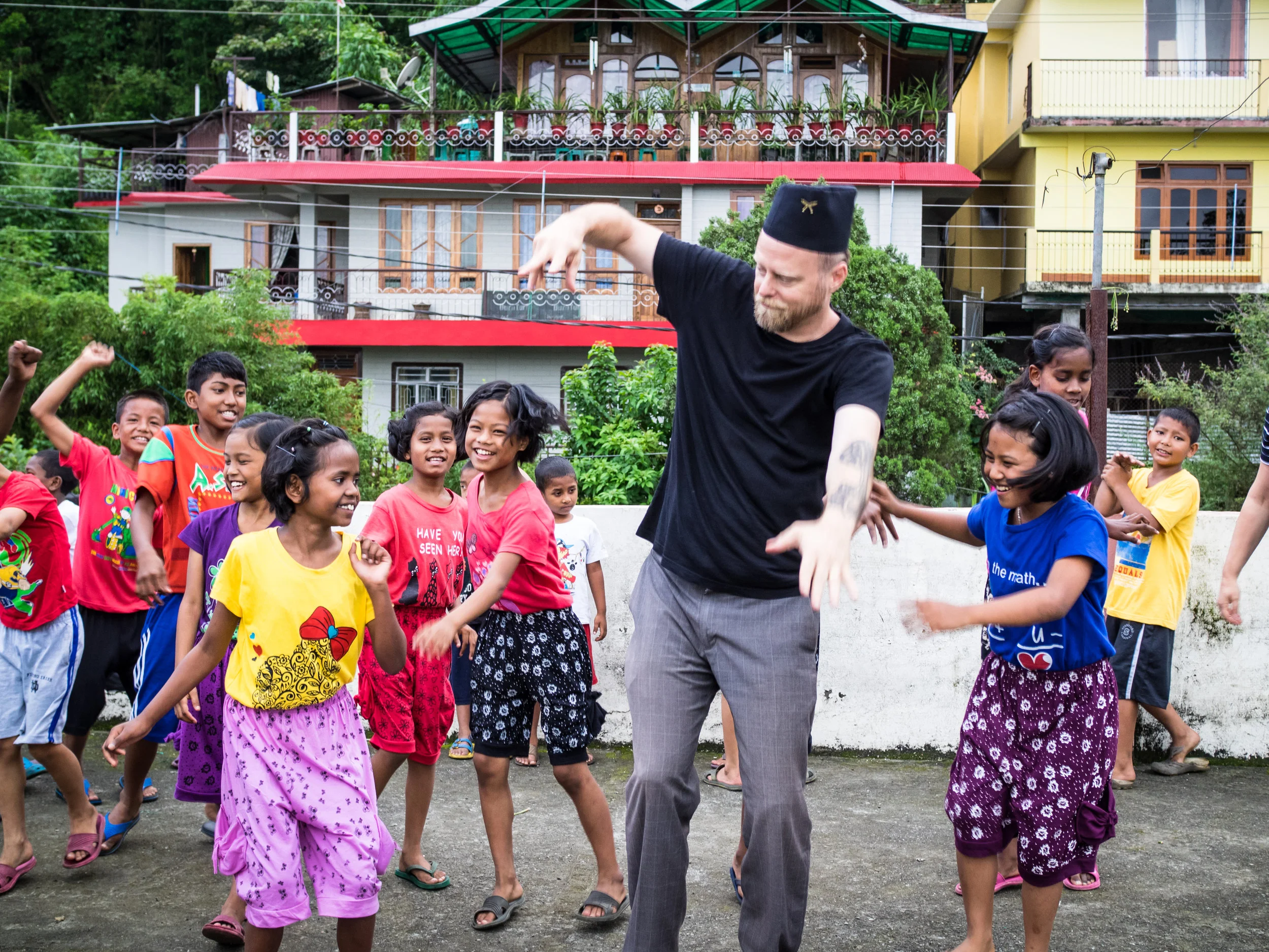 Executive Director John McCollum dancing with the kids at the Kalimpong 2 Children's Home in the foothills of India's Himalayan mountains.