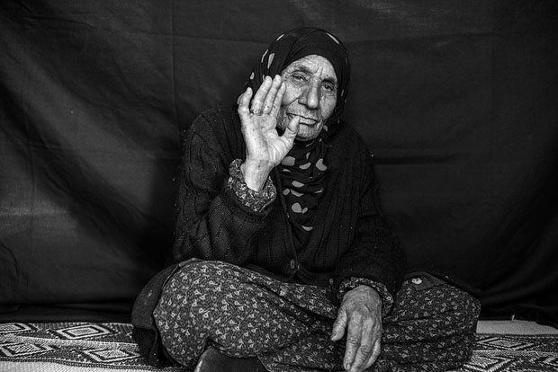 Salma, whose age is somewhere between 90 and 107 according to family members, poses for a portrait in Domiz refugee camp in the Kurdistan Region of Iraq