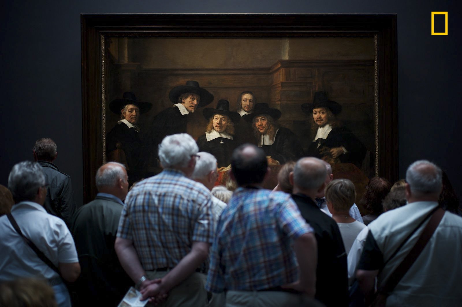 PEOPLE - 2nd Place. Photo and caption by Julius Y./ National Geographic Travel Photographer of the Year. Interesting moment . "Museum visitors curiously watching Rembrandt’s painting 'Syndics of the Drapers’ Guild' where it gave the illusion that the people on the paintings too are curiously watching the visitors."