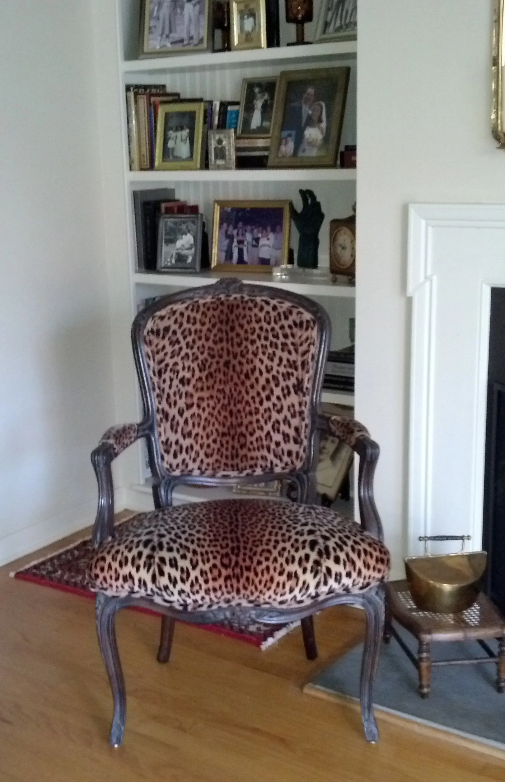Here, the homeowner makes a singular bold statement with a leopard-print armchair flanking the fireplace.