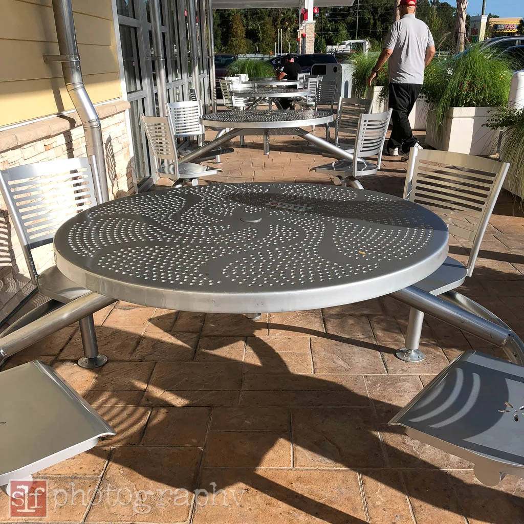 there are tables in sun as well as some in the shade