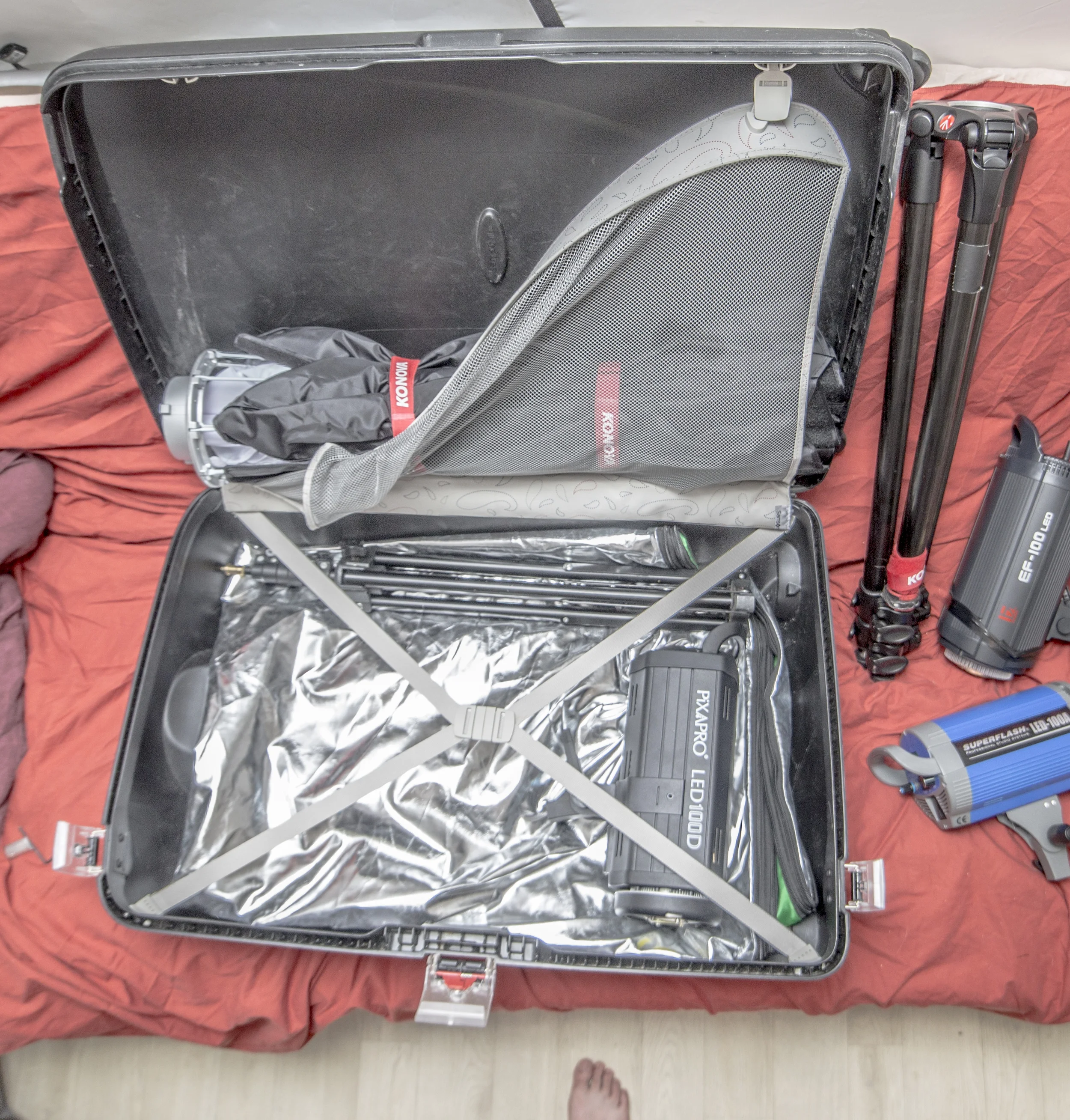 The Samsonite case has enough space for 3 LEDs, 3 Octoboxes and 3 large light stands with some space to spare. The fabric from the large reflector is used as padding under the lights and the Octoboxes provide the top padding.