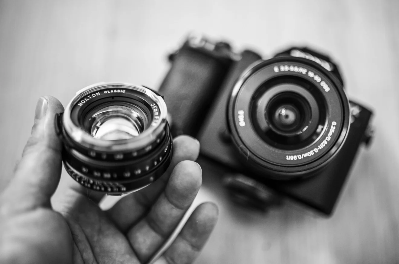A close up of the tiny little Voigtlander next to the A7 with the almost-pancake (half a cupcake maybe?) Sony 16-50mm.
