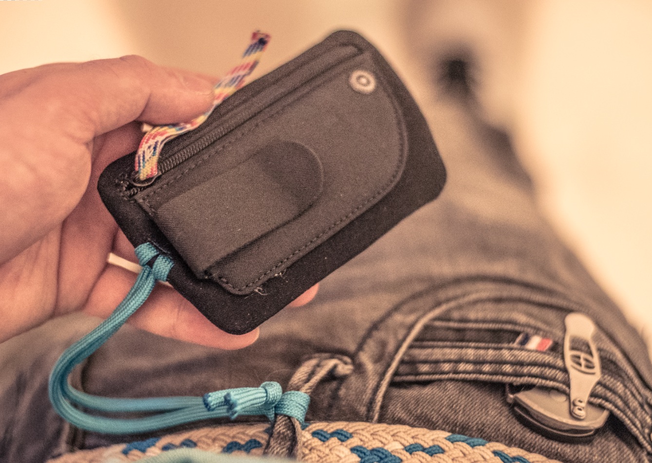 The Go 887 travel wallet . I added a couple of strings, one for securing to my belt loop and another as a replacement to the metal zip pull-tab thing. And I removed the "Go" logo tag.