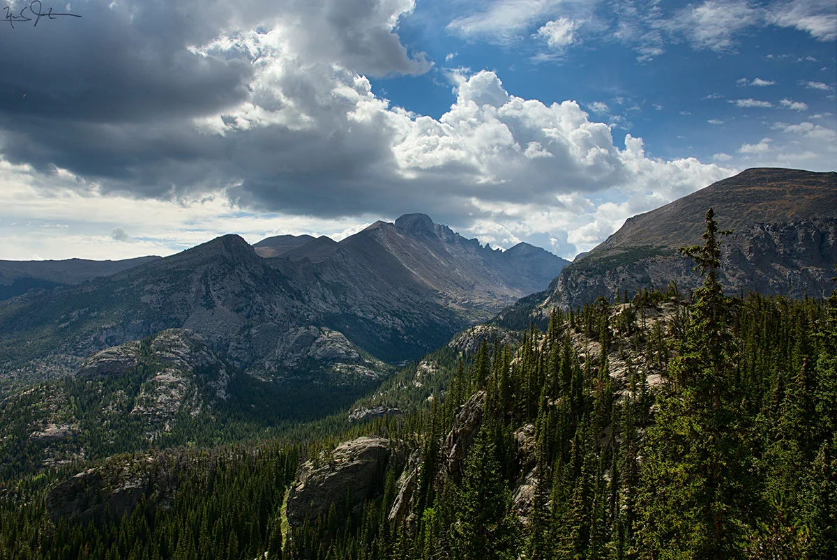 Afternoon clouds fore-sage a thunderstorm as they gather above the helmet of Long's Peak.