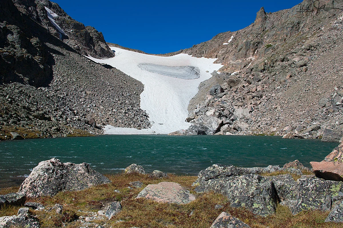Andrews Glacier - not much more than a dirty patch of snow in late Summer - and getting smaller every year because of the effects of human activity on our climate. Above the glacier is a saddle that is part of the Continental Divide - the line that determines whether water drains into the Atlantic or Pacific Ocean.
