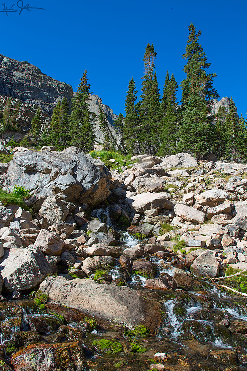 The middle reaches of Andrews Creek cascade over boulders below Andrews Tarn.