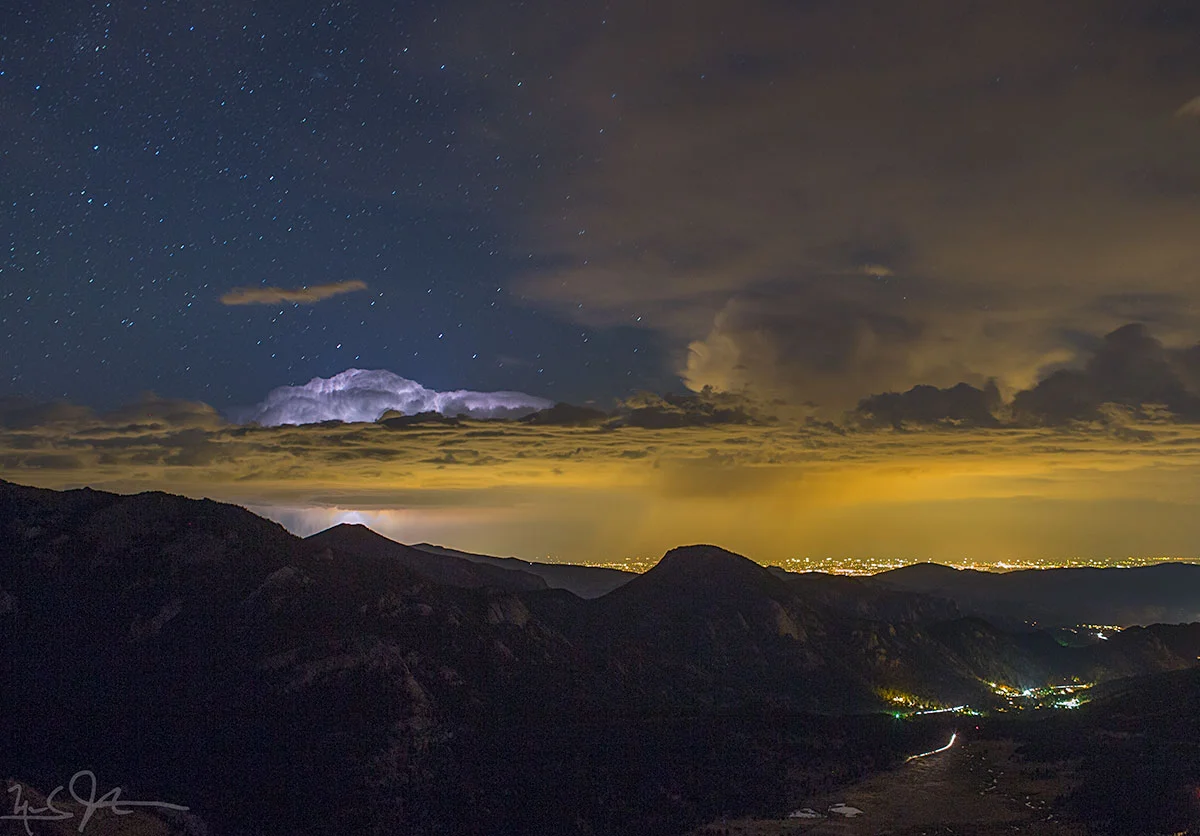 Distant clouds are lit by a lightning bolt.