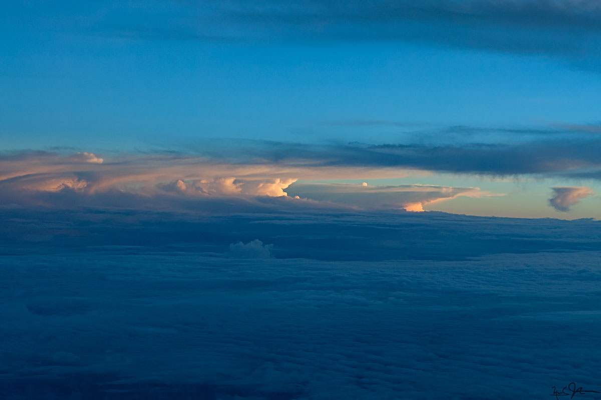 Early afternoon thunderheads forming in the distance. Climbing out of Tokyo's Narita airport bound for San Francisco.